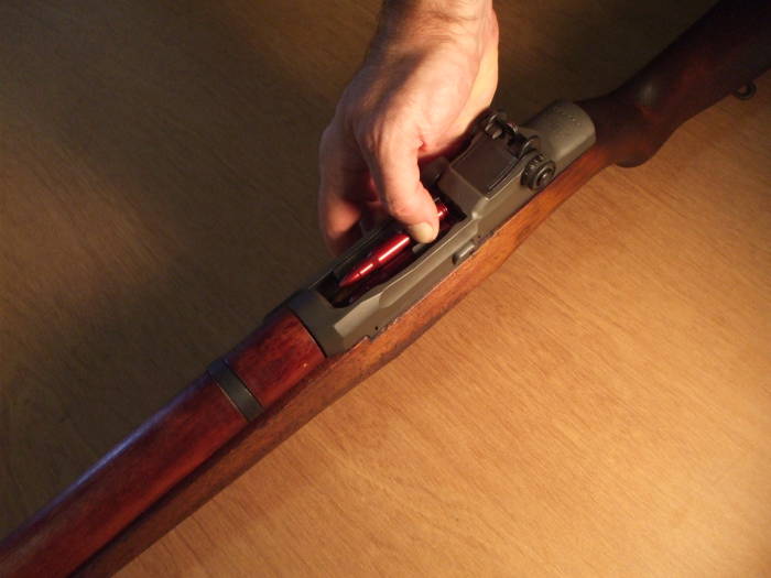 How to safely load an M1 Garand: block the operating rod handle with the heel of your left hand.