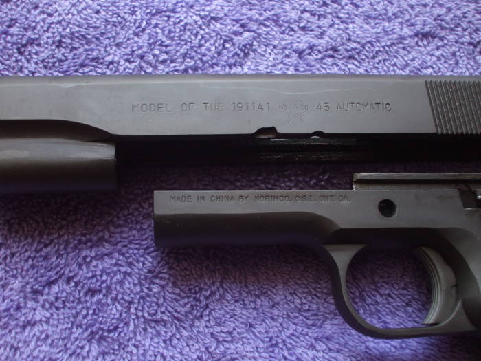 Frame and slide of a parkerized M1911 pistol.