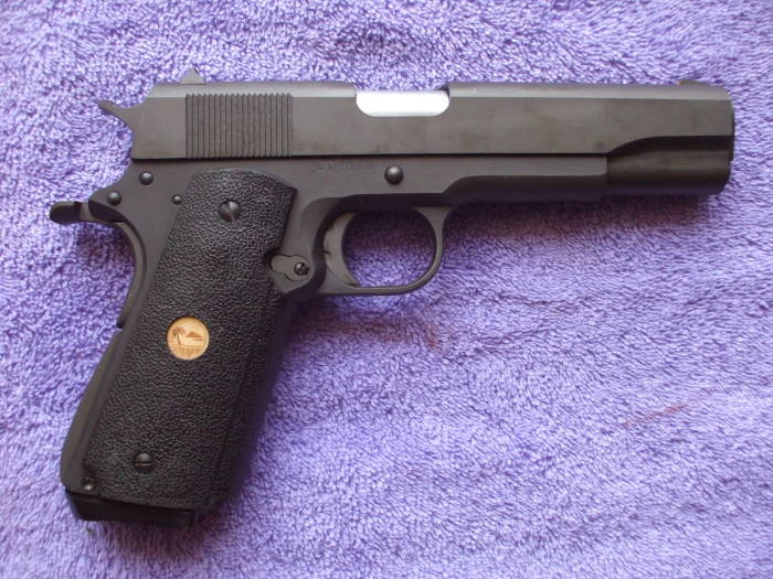 Reassembled parkerized M1911 pistol.