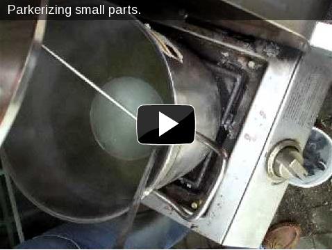 Video of parkerizing: small gun parts in a stainless steel ladle, the solution starts bubbling immediately.