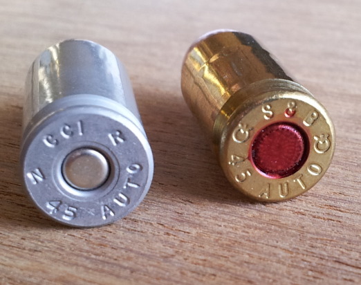 Headstamps of .45 ACP cartridges in brass and aluminum cases. CCI / Blazer aluminum case, Sellier and Bellot brass case.
