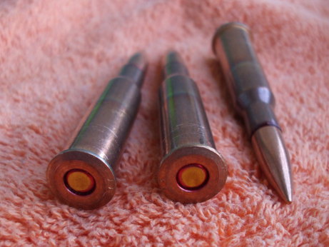 Three 7.62x54mmR cartridges showing primers and headstamps.