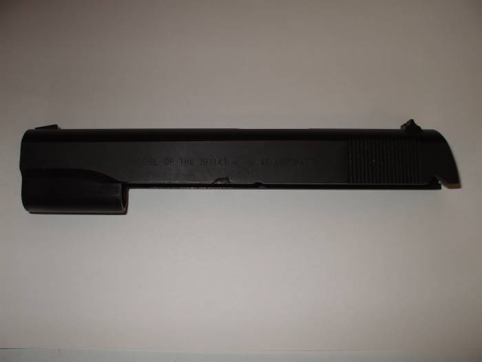 M1911A1 pistol slide.  Original finish from Norinco, nearly black uneven blued steel surface.