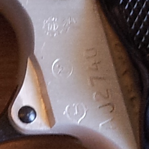 Serial number, acceptance stamp, and inspection stamps on the frame of a FÉG PA-63 pistol.