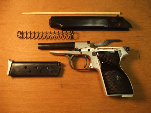 FÉG PA-63 pistol field stripped to its major components.