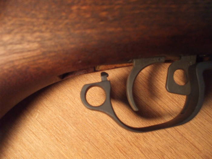 Disengage this latch at the rear of the trigger guard.