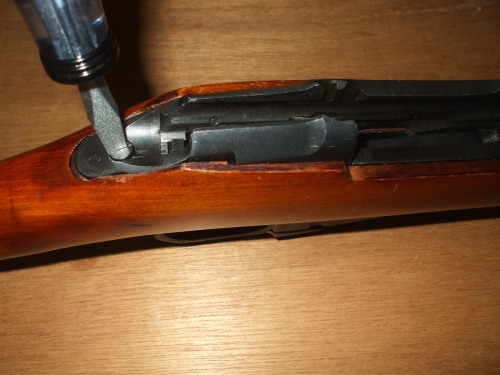 Remove the upper screw holding the magazine to the receiver.