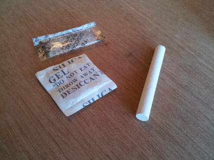 Desiccant packs and a stick of chalk.