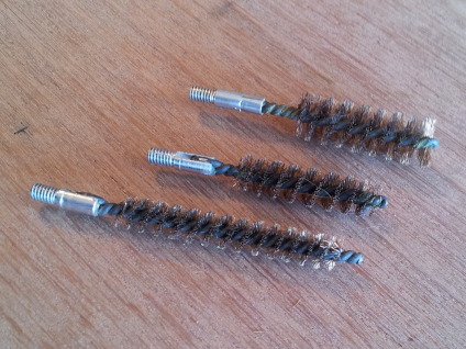 Bronze brushes for cleaning gun bores.
