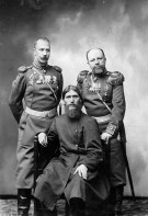 Tsar Nicholas II of Russia at left, Rasputin seated.