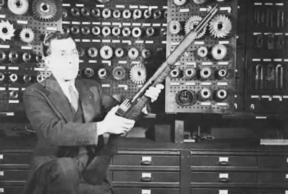John Garand with his T1E2/M1 design in the Springfield Armory shop.
