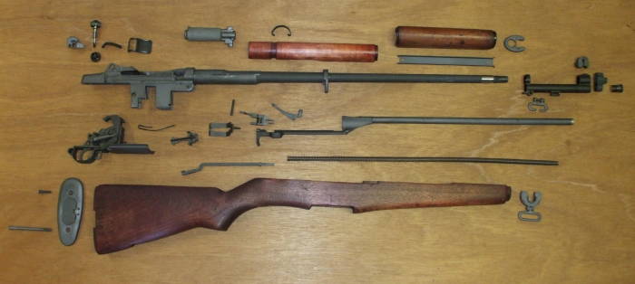 M1 Garand rifle collection of parts ready for assembly.