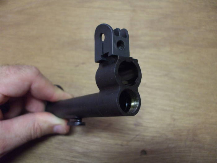 M1 Garand rifle, front sight being placed on gas cylinder.