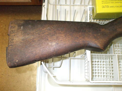 Dishwasher cleaning of an M1 Garand rifle stock.  Dark and dirty wood before cleaning.