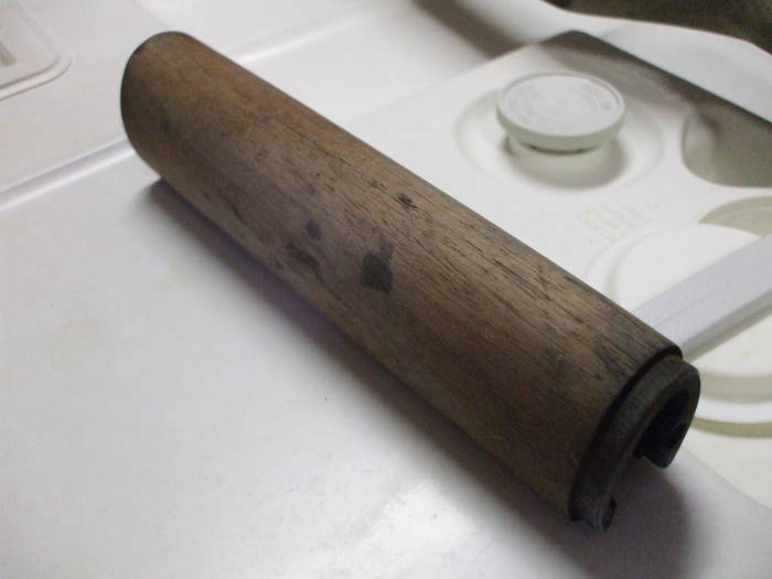 Dishwasher cleaning of an M1 Garand rifle stock.  Light wood after cleaning, although some dark oil stains remain.